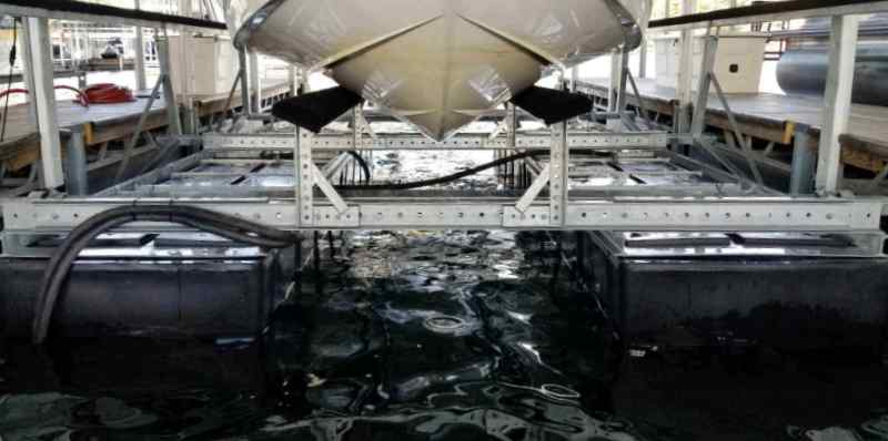 photo of one of LOTO Lift's rust-resistant boat lifts up close with boat on it